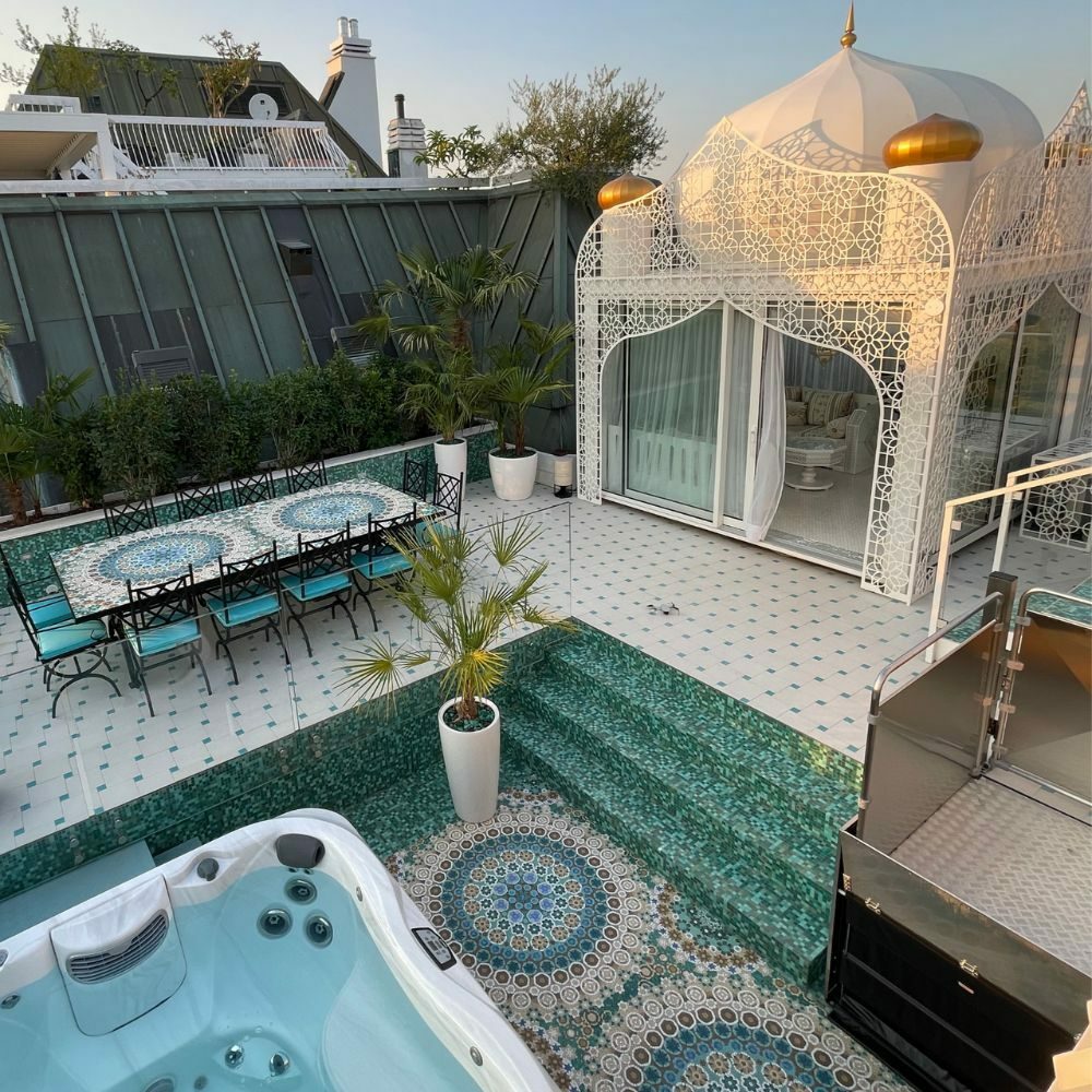 Terrace with Arabian-style tent. Dining table to the left and Jacuzzi. luxury residential architect